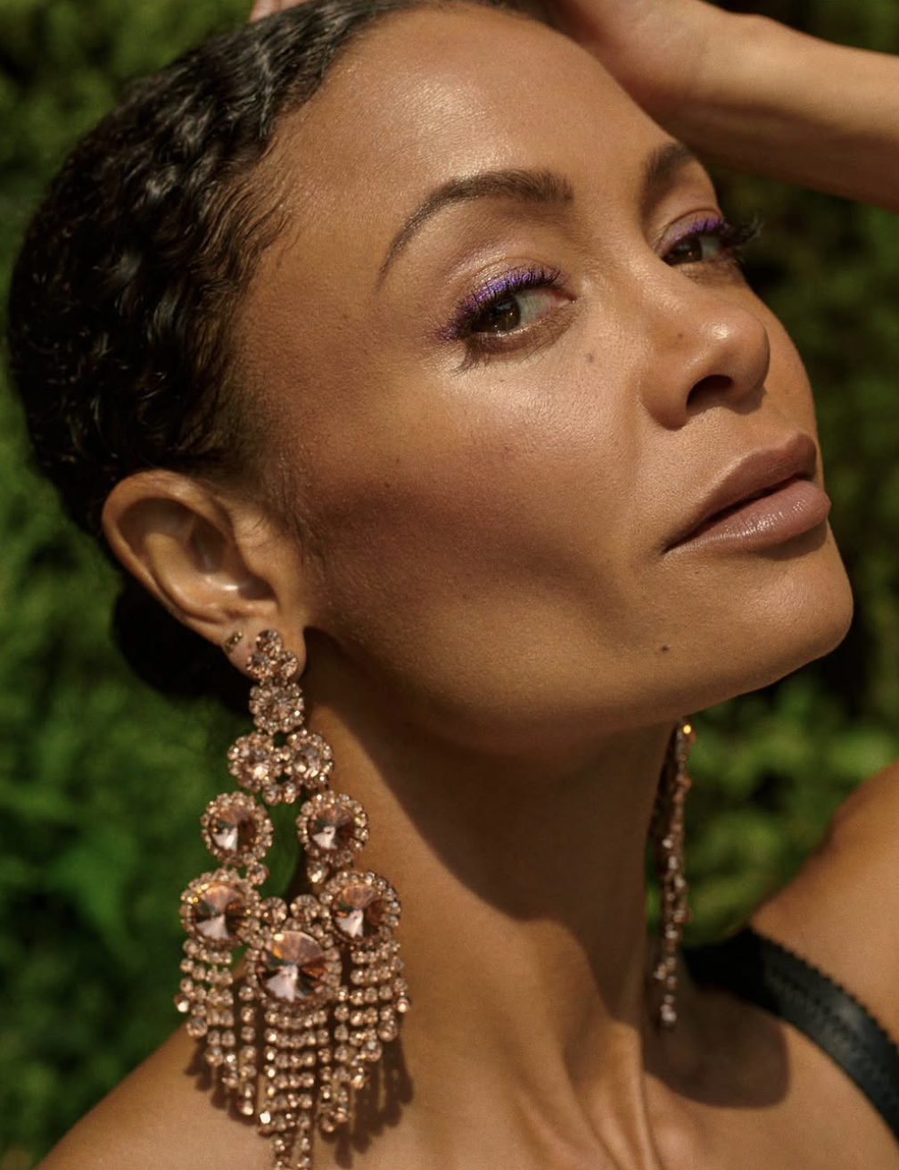 Thandiwe Newton wearing statement crystal drop earrings and purple eyeliner, illustrating how high-contrast details and cool-neutral deep tones harmonize with the Deep Winter season.