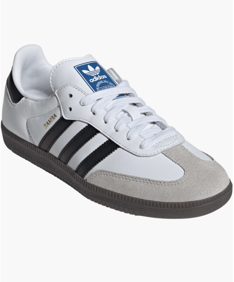 A pair of white and black adidas Samba OG sneakers with gum soles, styled as trendy and professional work sneakers for a business-casual office.