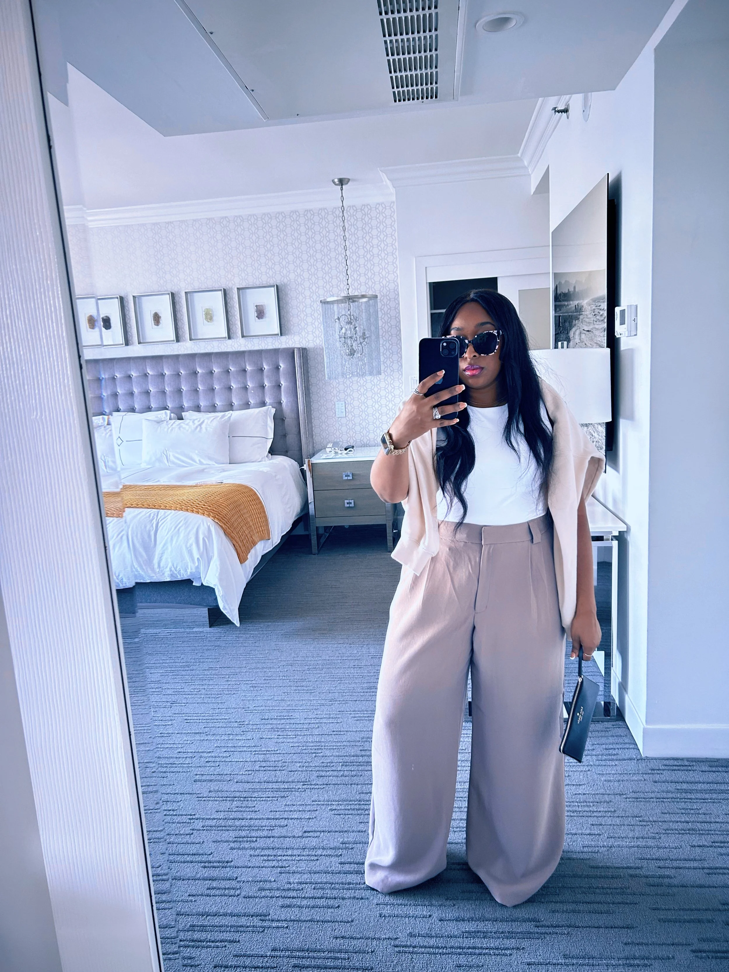 Fashion editor Autum Love wearing a navy Malibu crewneck sweatshirt and light blue Old Navy wide-leg trousers with a gold chain belt in Santa Monica.