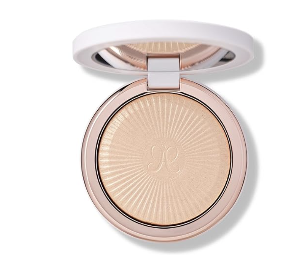A close-up view of an open Anastasia Beverly Hills cream bronzer compact showcasing the smooth, sun-kissed tan makeup product inside a white and gold case.