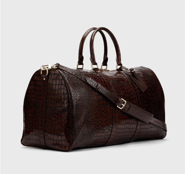 Croc-embossed leather duffle bag with a large interior for multi-day travel.