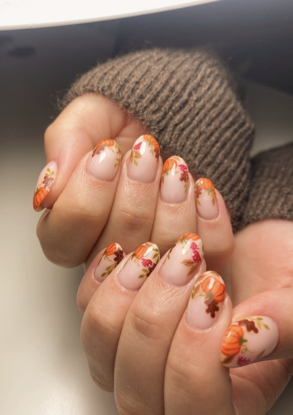 Detailed pumpkin-patch nail art with vines, leaves and pumpkins