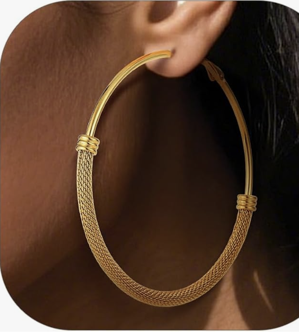 Close up of chunky gold hoop earrings, a top trending accessory for spring 2026 wardrobe essentials.
