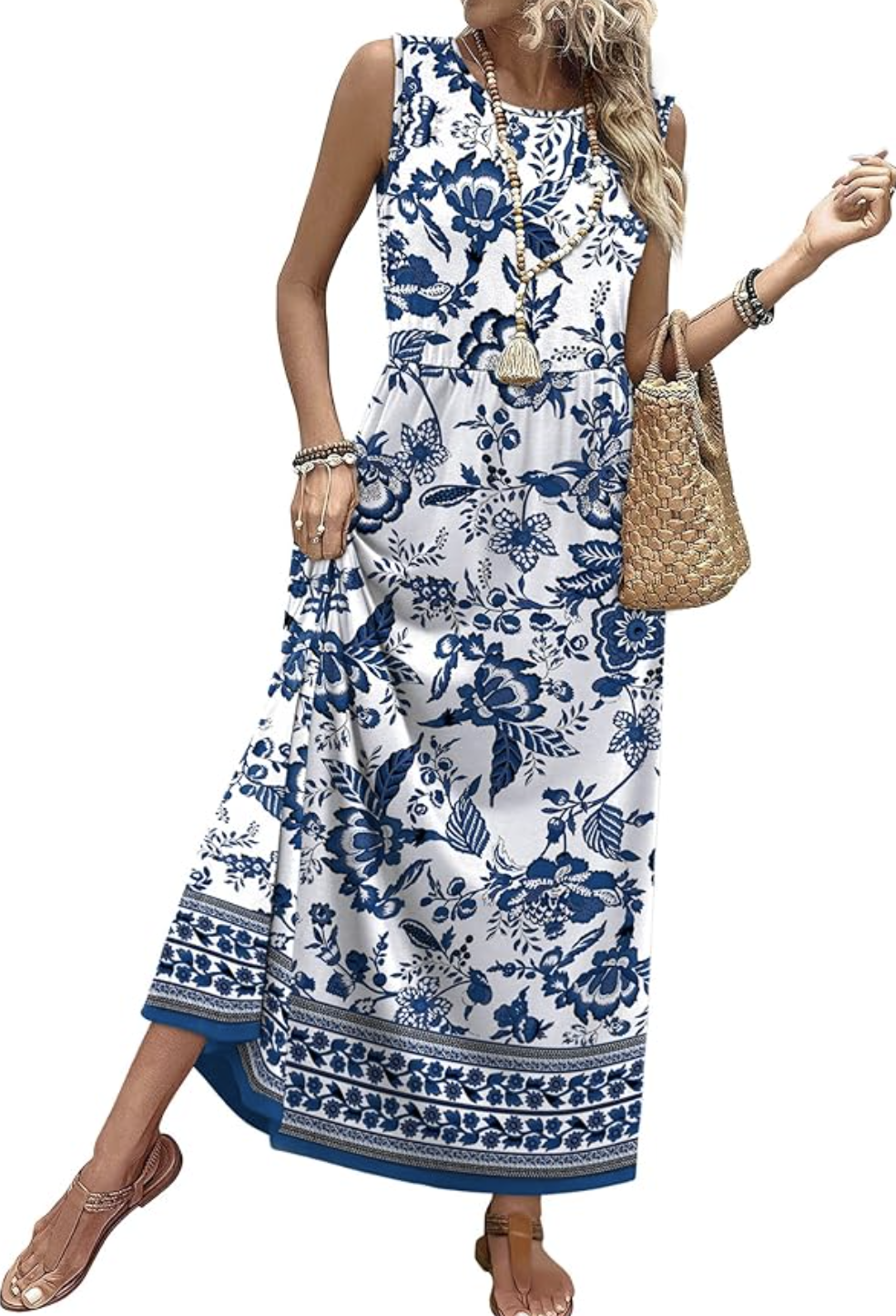 A woman wearing a white and blue ethnic floral print maxi sundress with a tiered A-line skirt and brown gladiator sandals.