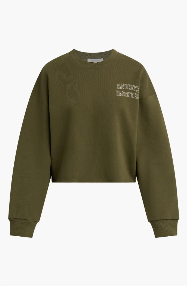 An olive green cropped collegiate sweatshirt with "Favorite Daughter" embroidered on the chest, paired with high-waisted denim for a casual look.