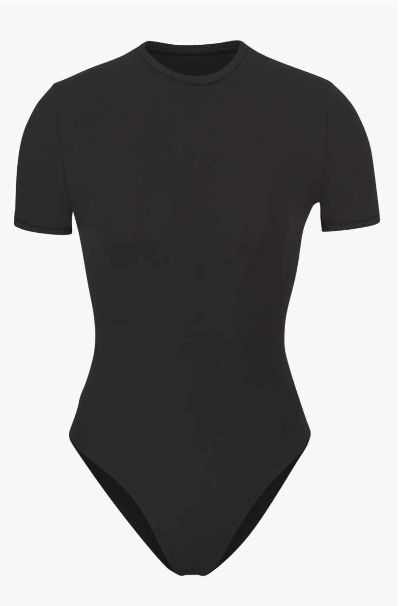 Product view of a black SKIMS Fits Everybody T-Shirt Bodysuit with a crew neckline and short sleeves.