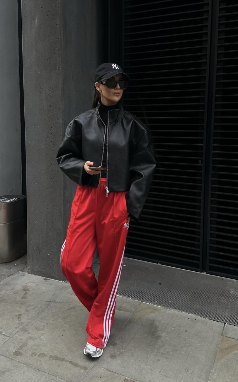 Red Adidas track pants paired with metallic silver sneakers.