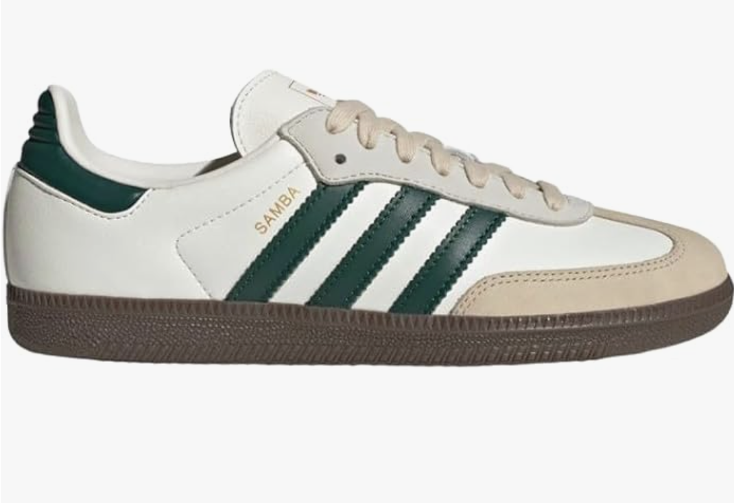 A pair of white Adidas Samba OG sneakers with dark forest green stripes and a brown gum sole, styled for a casual outfit.