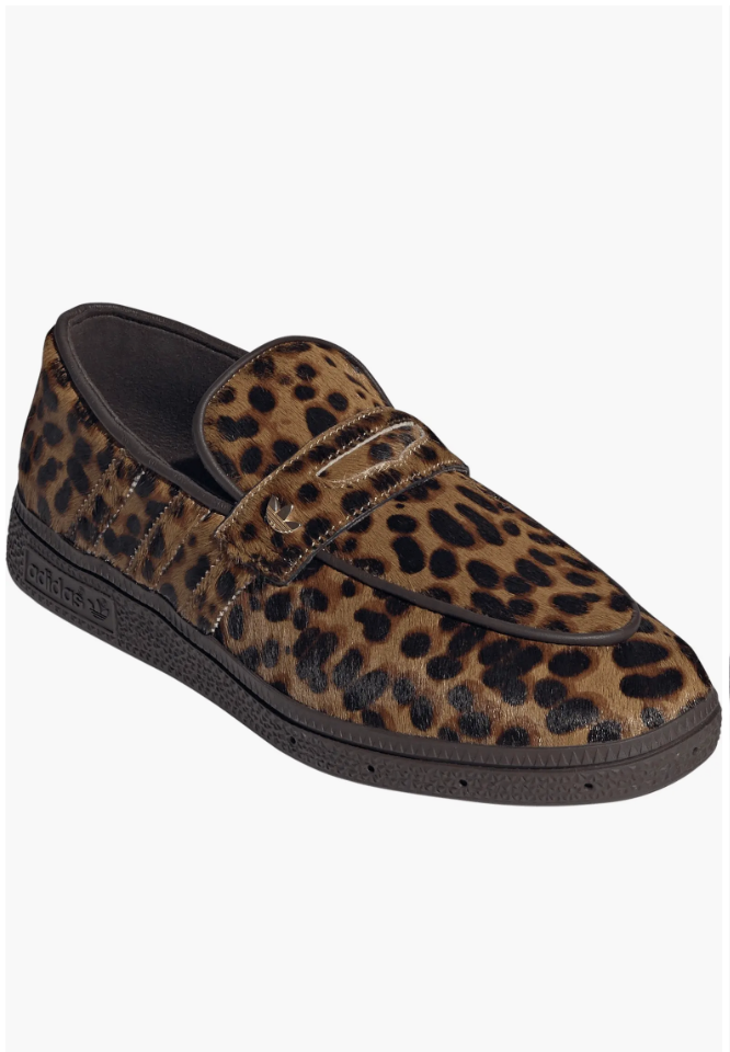 Leopard print pony hair loafer featuring a classic penny-loafer strap and a dark brown textured rubber outsole.