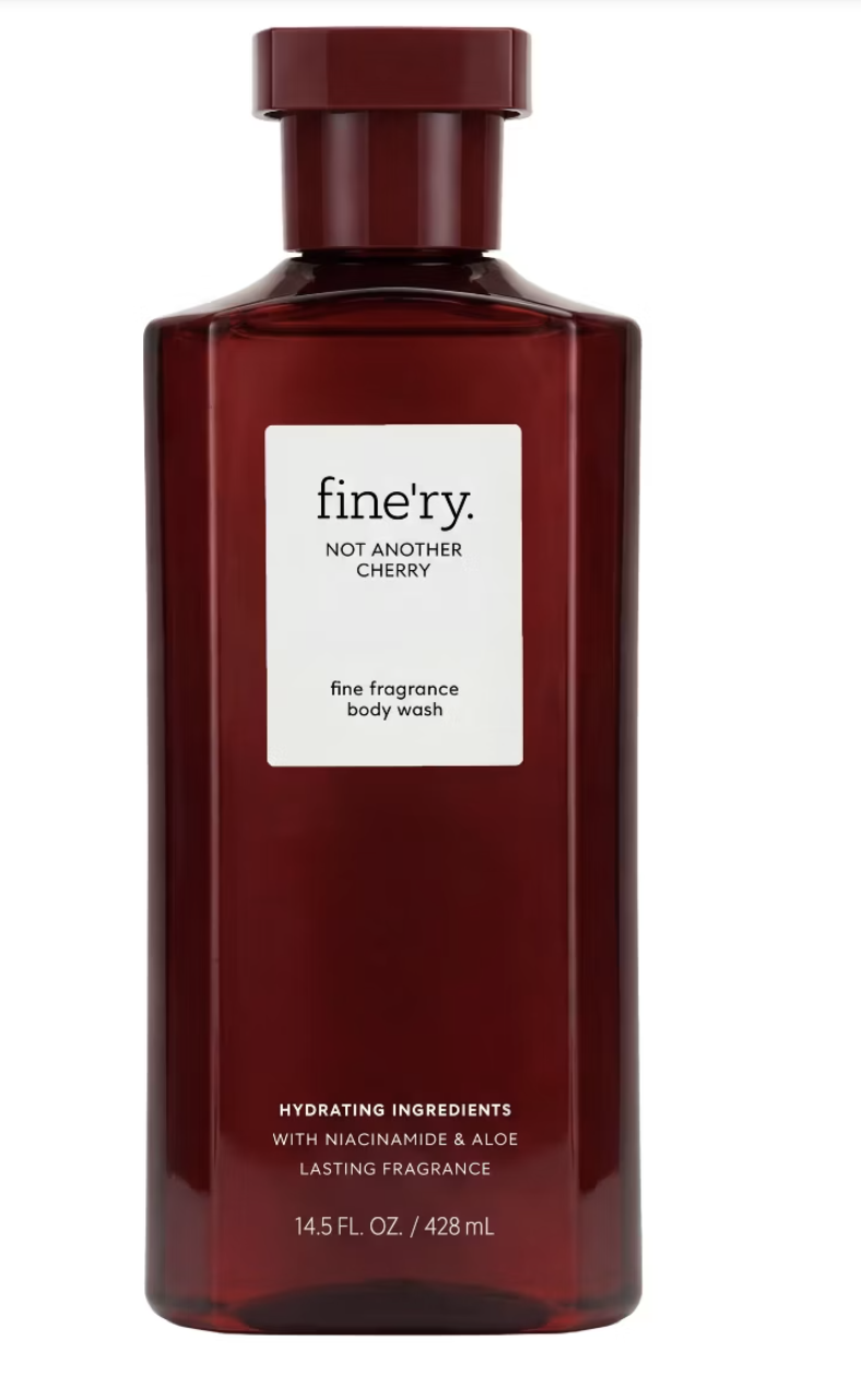 A rectangular, deep cherry-red bottle of Fine’ry Not Another Cherry fine fragrance body wash with a white label, containing 14.5 fl. oz. of product.