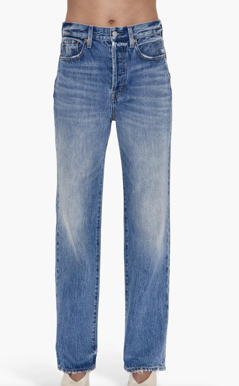 A pair of Pistola Cassie high-waist straight-leg jeans in a medium wash with a slight distressed hem, styled to be worn with flats for women.