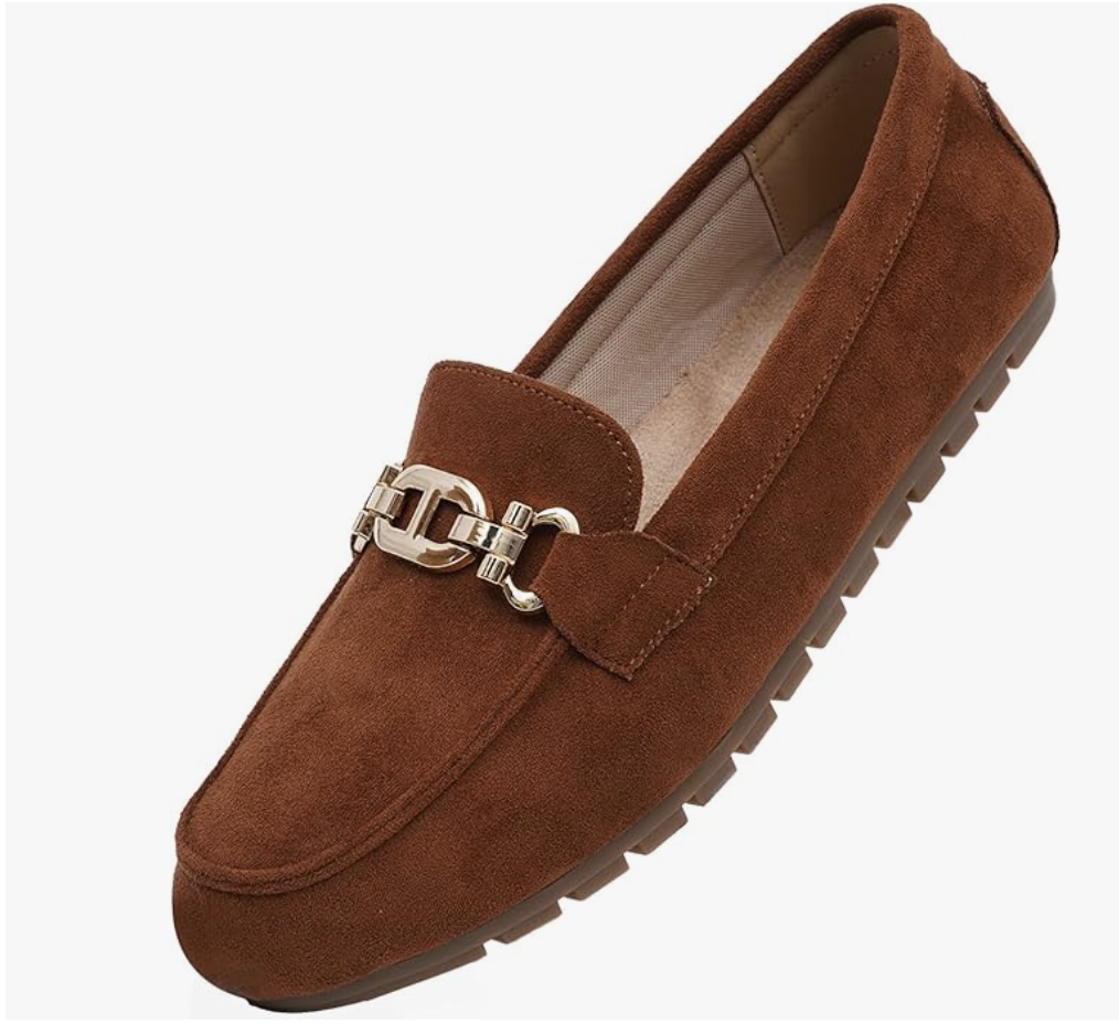 A pair of brown suede loafers with a gold metal bit detail and a thick cushioned sole, styled as a comfortable and polished shoe option for a spring capsule wardrobe for women in their 60s.