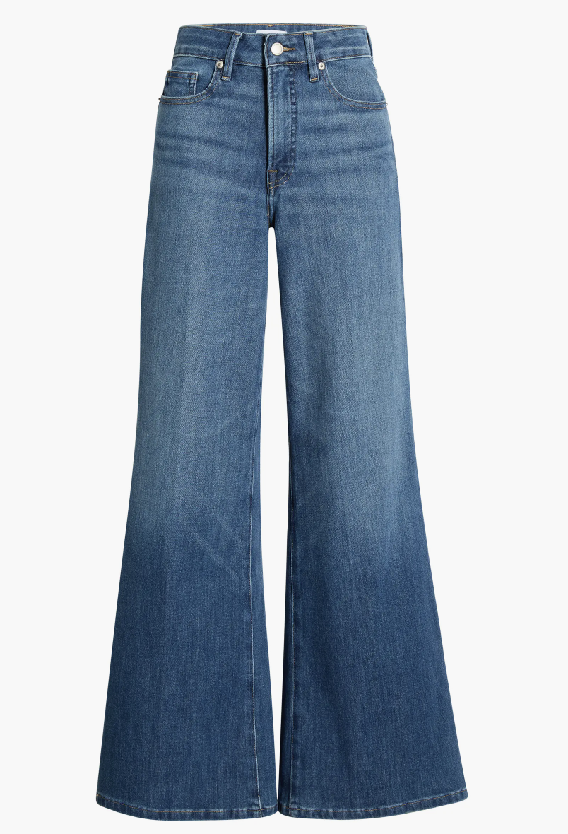 Model wearing Good American Soft-Tech Good Waist Palazzo Jeans in a medium wash, showing the wide-leg flare and high-waisted fit ideal for rectangle body shapes and athletic builds.