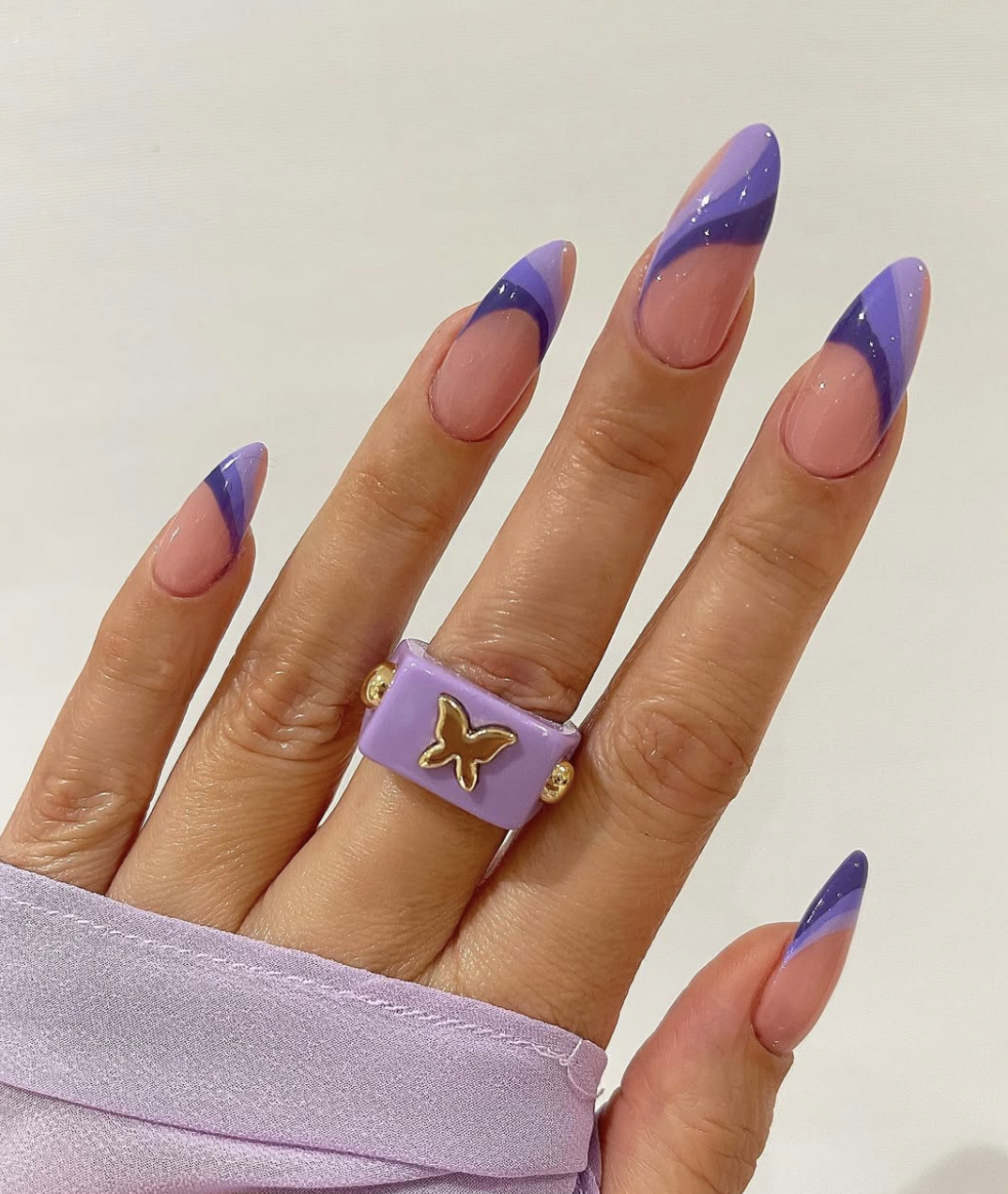 Almond-shaped nails with electric-purple French tips