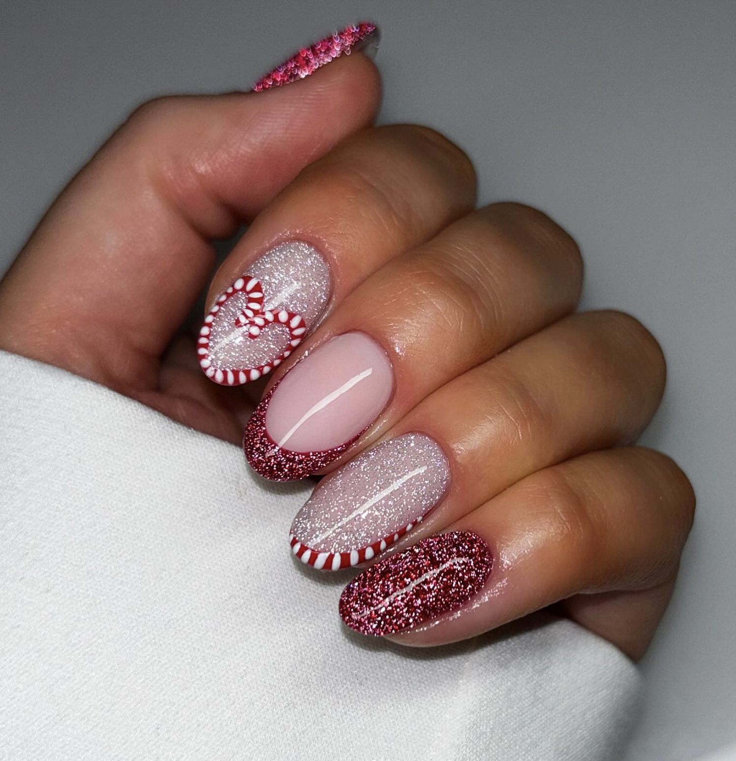 Candy cane micro French Christmas nails with red and white striped tips