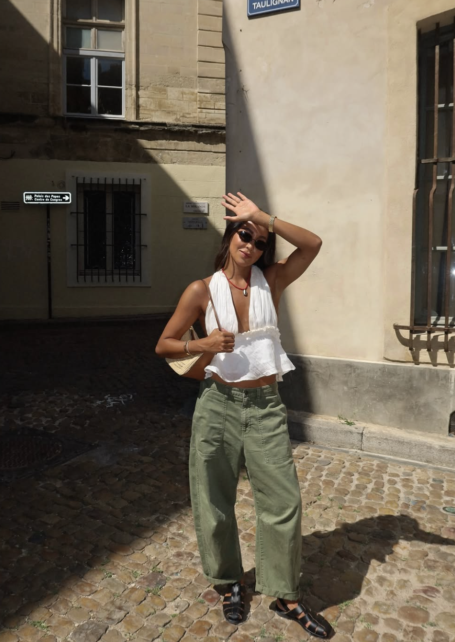 A casual olive green pants outfit paired with a cream sweater and beige accessories.