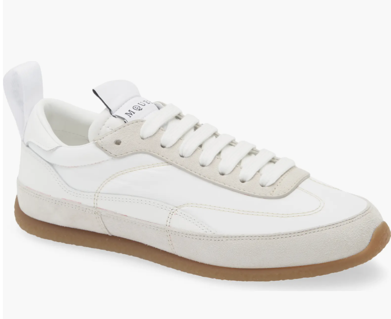 A pair of white leather McQueen EC1 sneakers with a gum sole, a polished and high-end option for professional work sneakers.