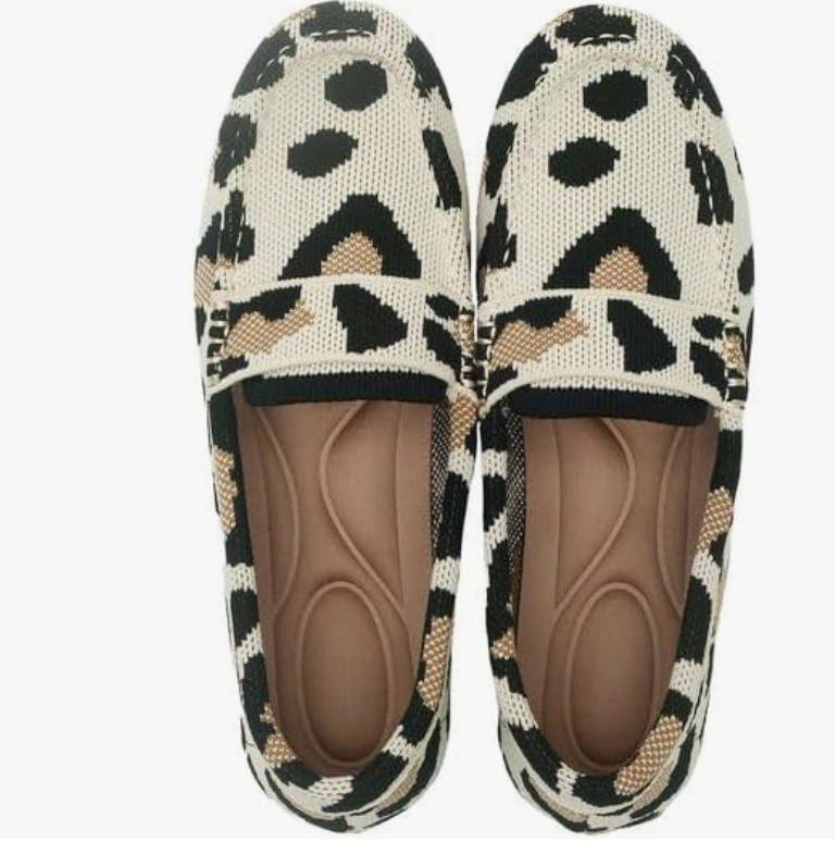 A pair of black and white leopard print pointed-toe knit flats displayed as a comfortable footwear option for a professional work capsule wardrobe.