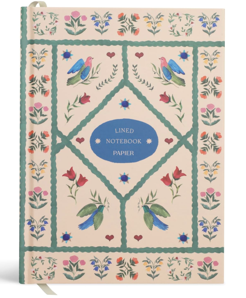Papier Quilted Daydreams lined notebook featuring a quilted pattern cover with folk-art style floral and bird illustrations in blue, green, and red.