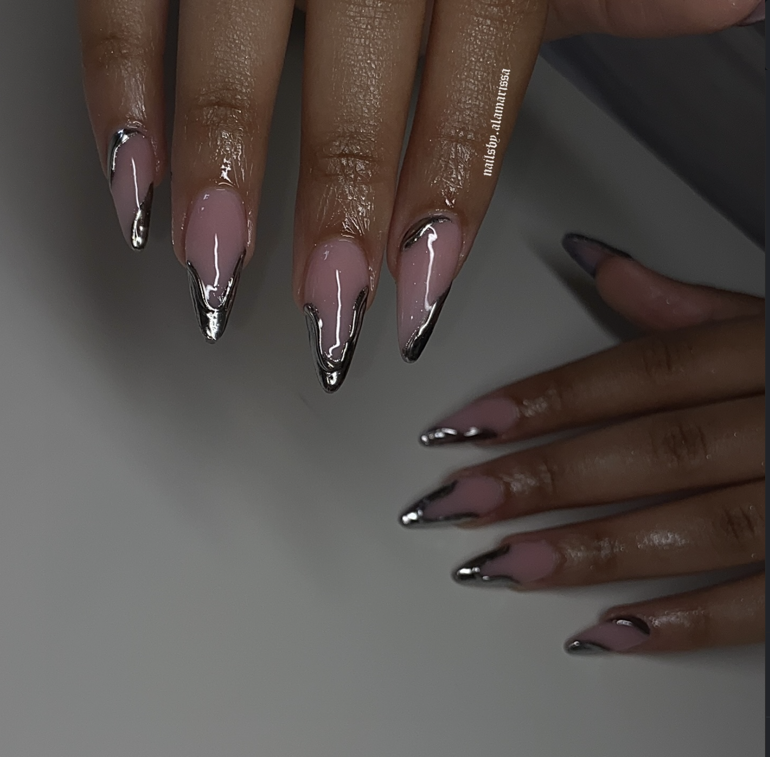 Short silver chrome nails with an icy metallic finish