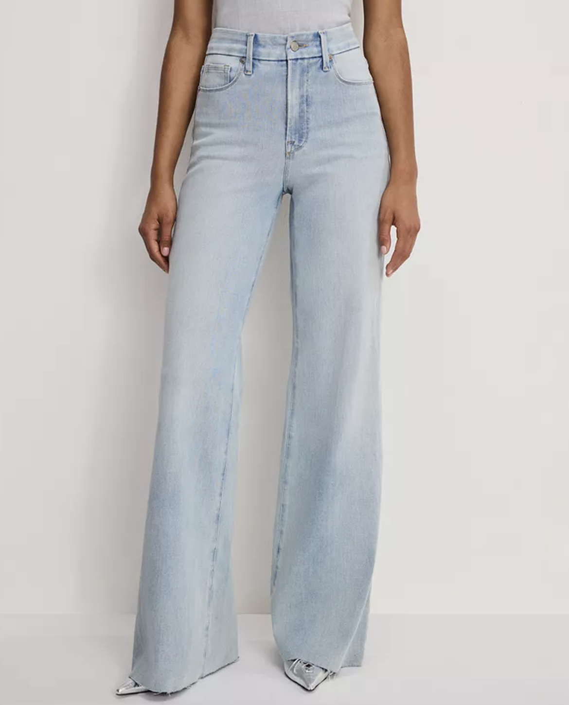 A pair of light blue Good American high-waisted palazzo jeans with an extra-wide leg and a clean floor-length hem.