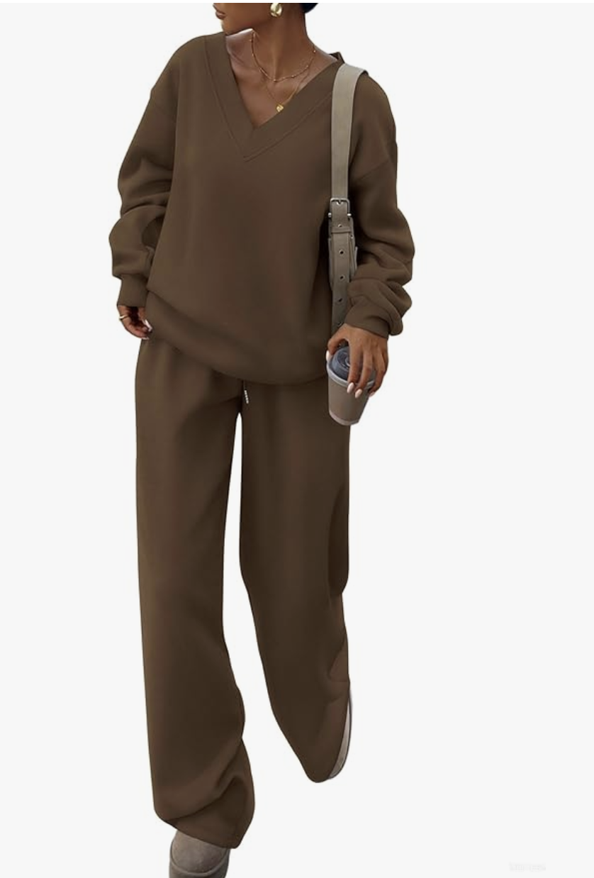 A woman wearing a chocolate brown oversized v-neck sweatshirt and matching joggers, styled as a cozy base layer for an effortless outfit.
