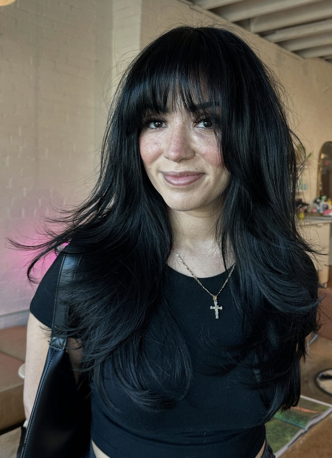 Woman wearing wispy long curtain bangs with soft face-framing movement