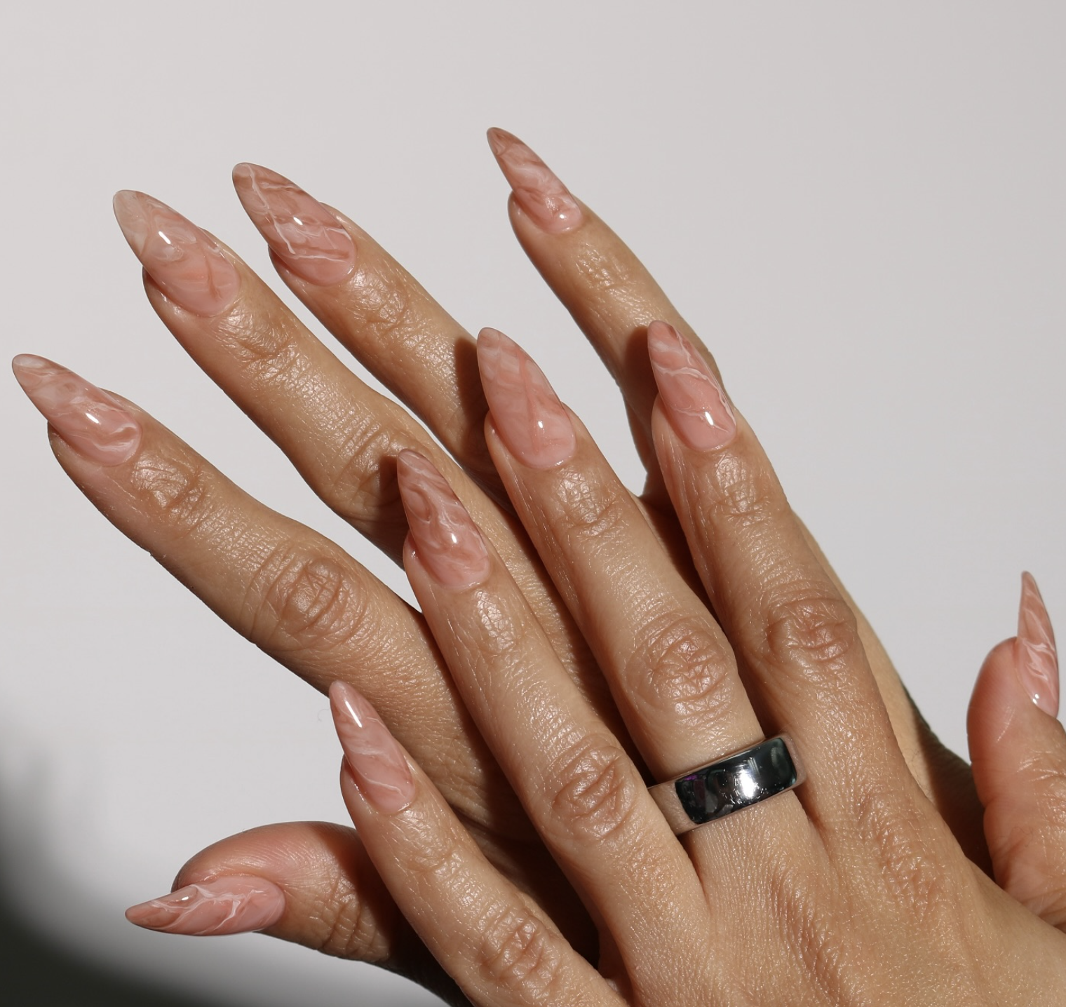 Short oval nails with a warm caramel pearlescent finish
