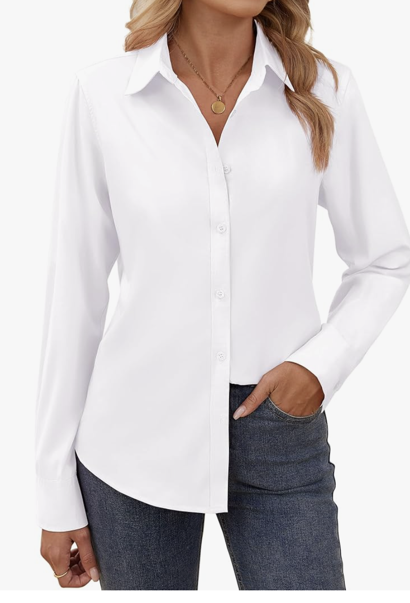 A woman wearing a crisp white cotton-blend button-down shirt tucked into jeans, showcasing a versatile and non-see-through investment staple for a 2026 capsule wardrobe.