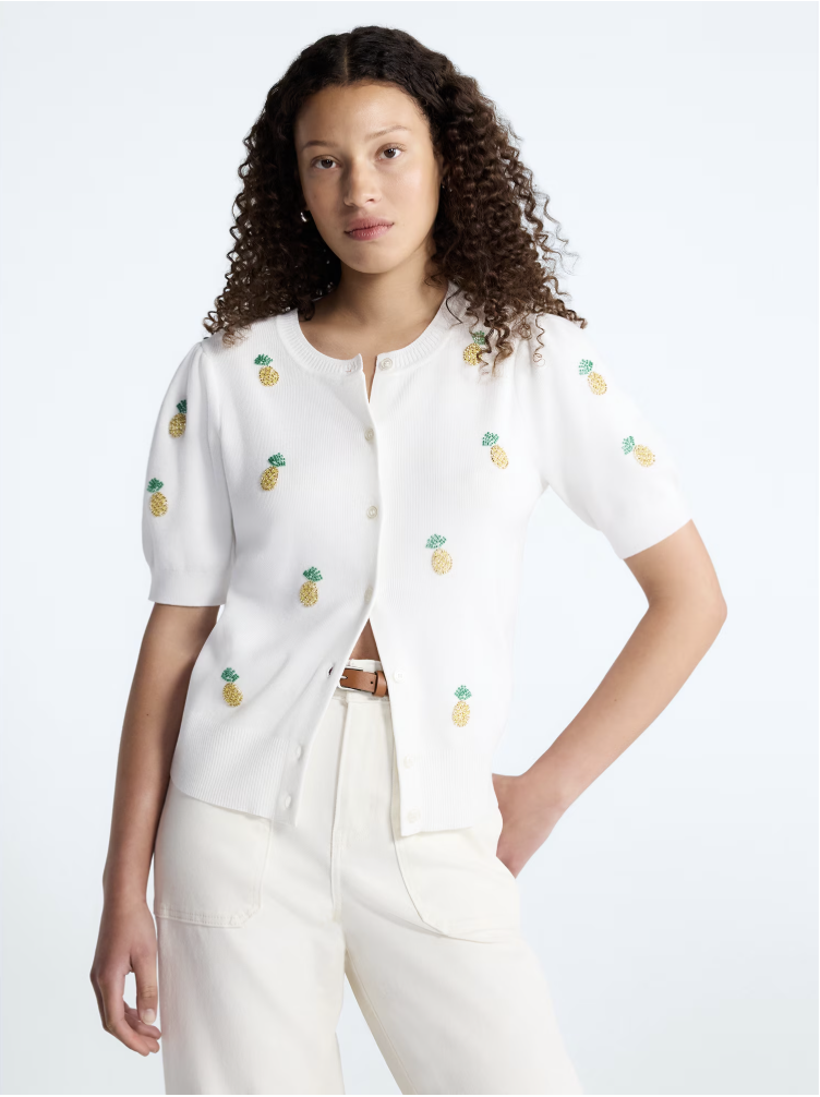A knit short puff-sleeve cardigan sweater adorned with delicate bead detailing.