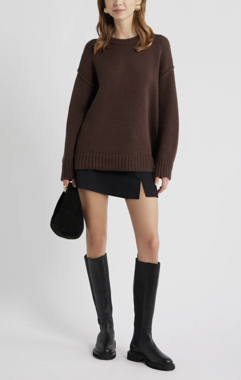 Product view of an oversized dark brown cotton crewneck sweater by Open Edit, styled with tall black boots.