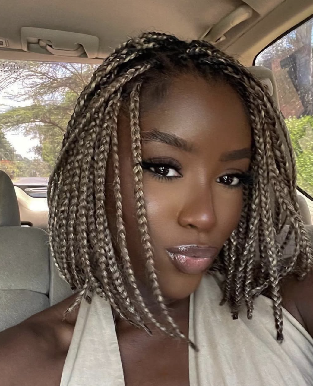Chin-length box-braid bob with an even blunt shape.