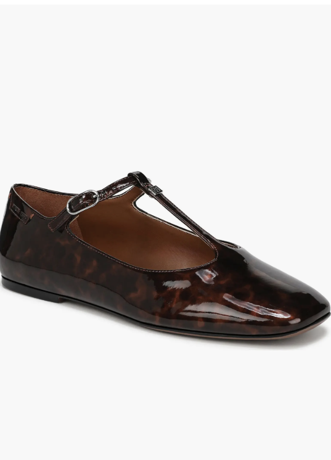 A close-up of the Franco Sarto Marylee T-Strap Flat in a polished tortoise shell finish, a sophisticated and professional "Quiet Luxury" footwear choice for a 2026 capsule wardrobe.