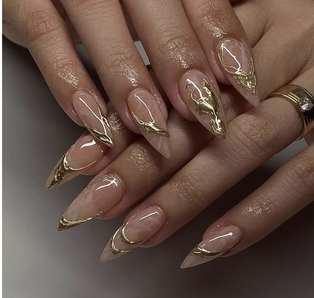 Medium almond-shaped press-on nails with a classic nude base and metallic gold 3D swirl French tips.