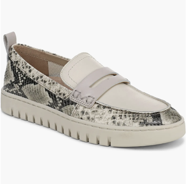 Chocolate supportive penny loafers paired with dark jeans and a striped sweater.