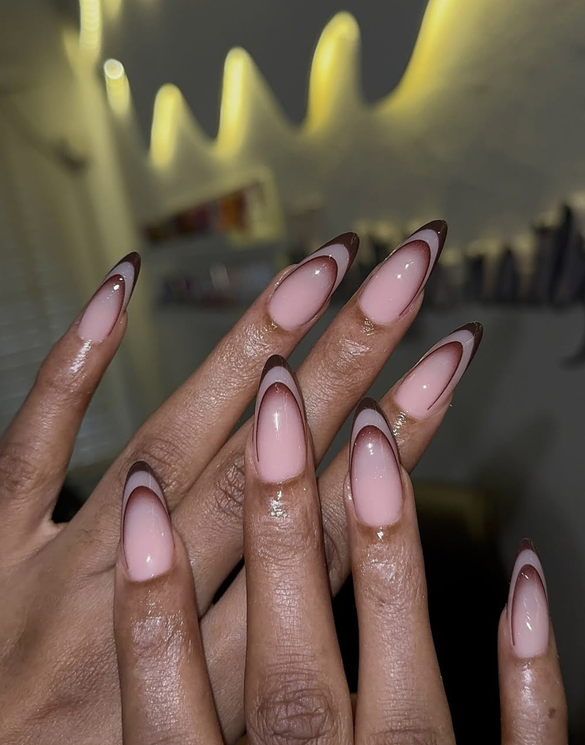 Espresso brown French tips over a sheer nude base on short nails