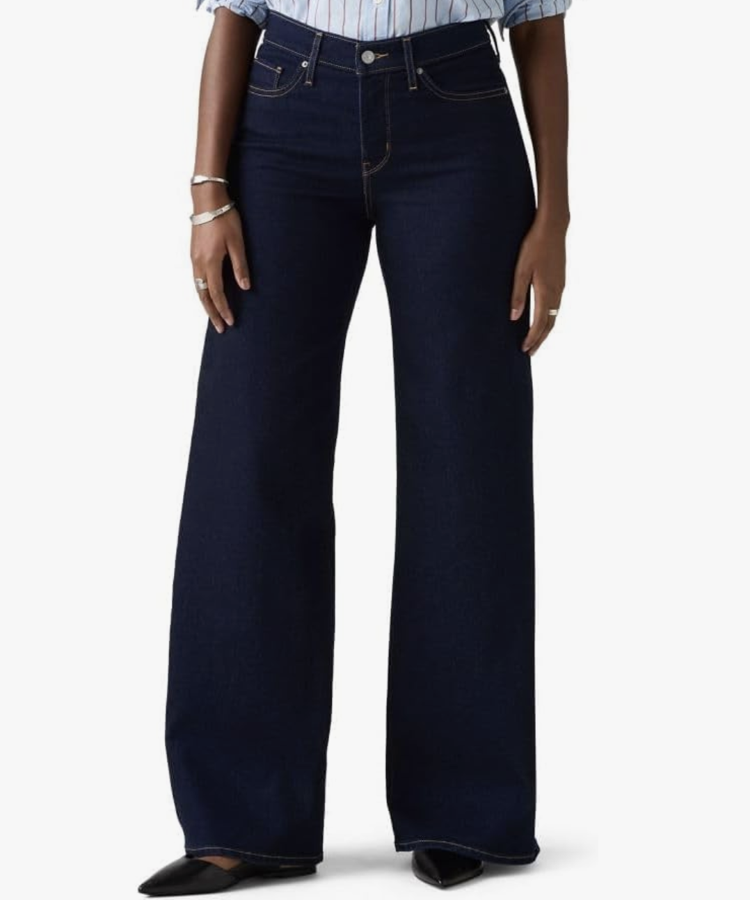 A pair of dark wash Levi's Womens 318 Shaping Wide Leg jeans from Amazon, designed to provide tummy control and a smooth silhouette when wearing a bodysuit.