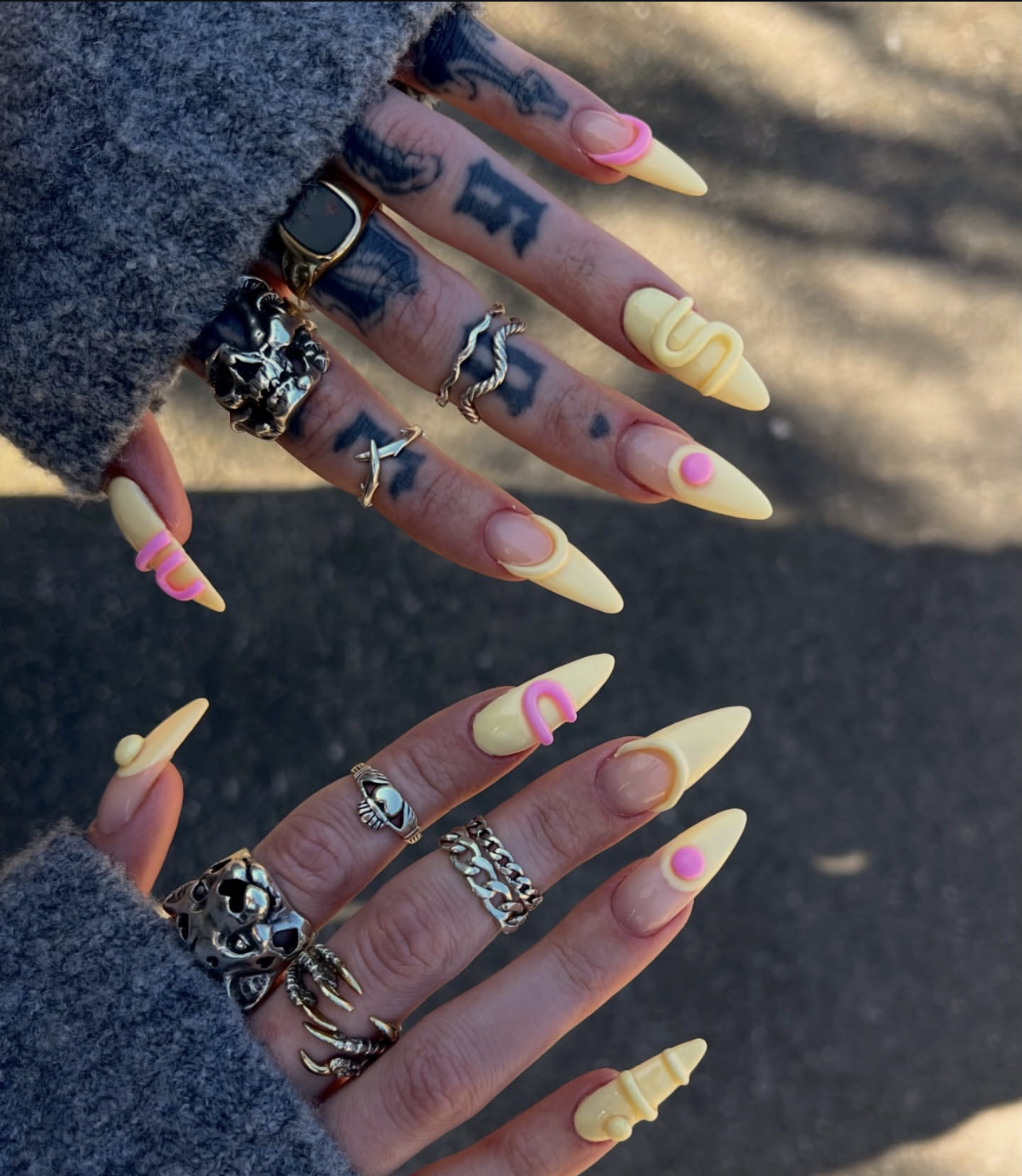 High-feminine stiletto nails by @_beautbybee featuring a butter yellow base with raised 3D pink abstract shapes, "drip" textures, and modern sculptural accents.