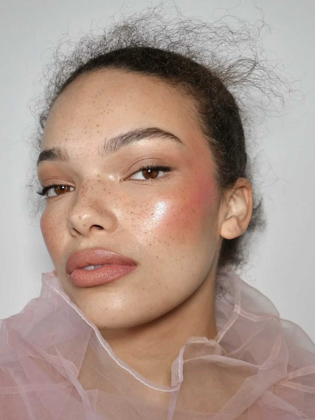 Natural real-skin makeup with freckles and texture visible