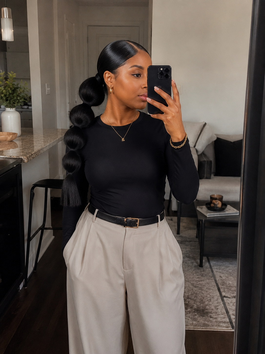 Silk press hair styled into a sectioned bubble ponytail