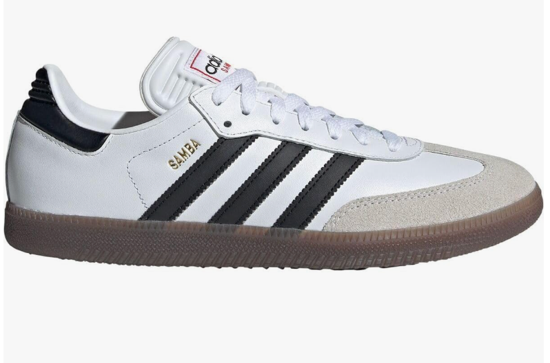 A product shot of the white and black adidas Samba OG sneaker with a gum sole, an editor-recommended footwear staple for balancing the volume of wide-leg jeans.