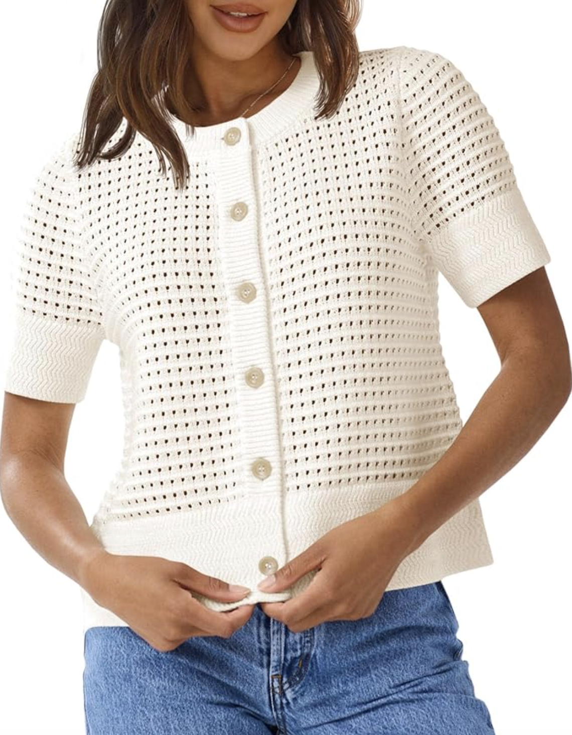 A woman wearing the Saodimallsu white short-sleeve crochet cardigan with a button-down front, styled with blue jeans as a textured lightweight layer for spring.