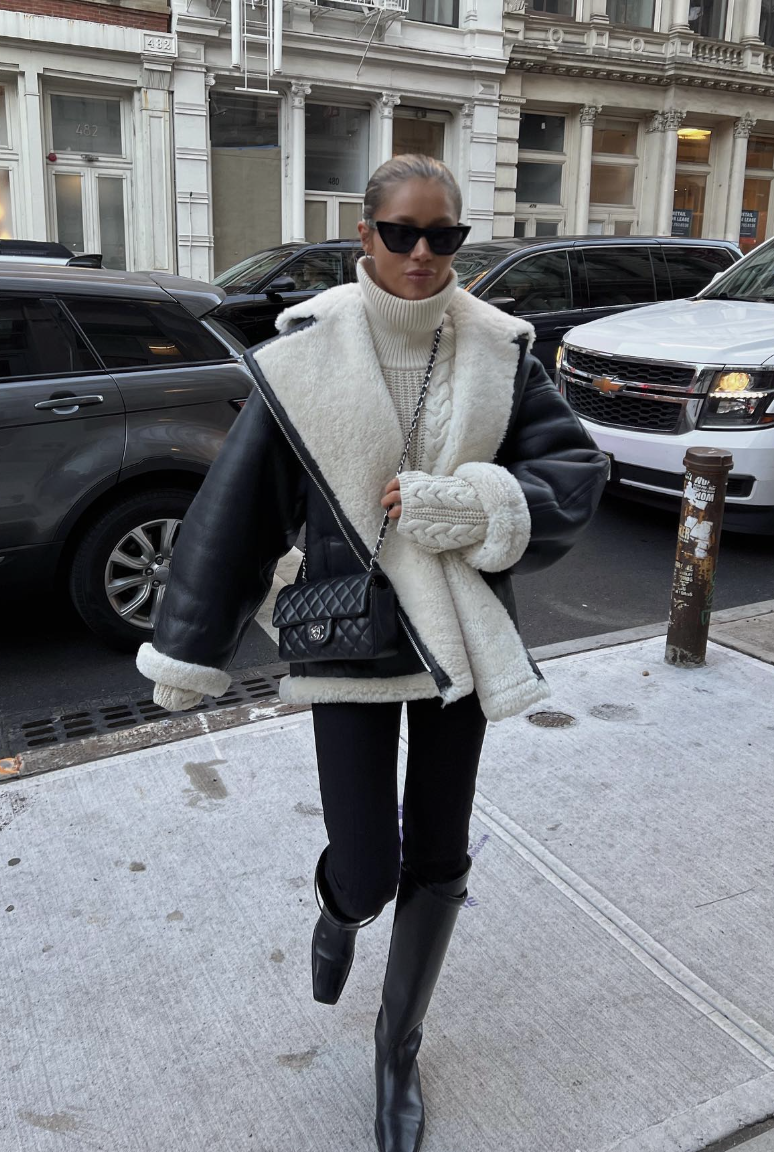 A shearling-trim aviator jacket with black leggings