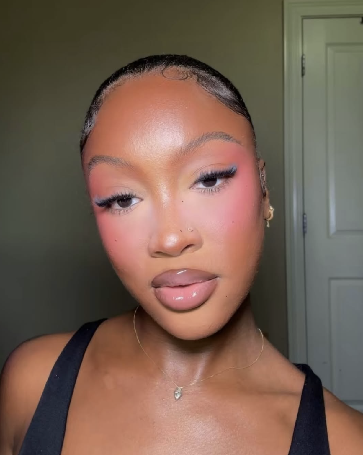 Woman wearing diffused cranberry blush high on her cheeks with natural-looking skin
