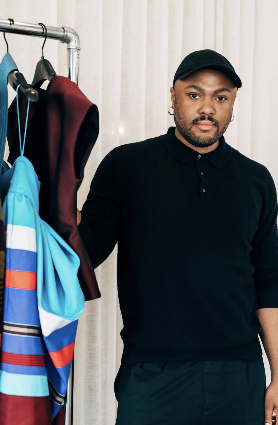 Designer Christopher John Rogers backstage at NYFW with models in colorful sculptural dresses, photographed by Meredith Jenks for Vogue.