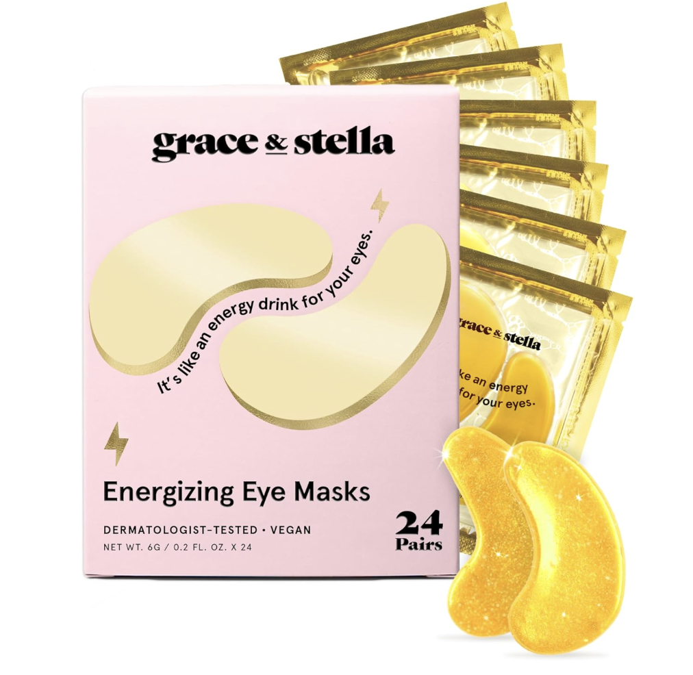 A pink box of grace & stella 'Energizing Eye Masks' containing 24 pairs, featuring a gold crescent-shaped eye patch and a slogan that reads 'It's like an energy drink for your eyes.'