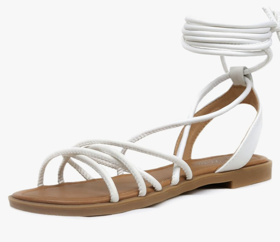 A pair of white strappy Lace Up Gladiator Sandals with a tan sole and wrap-around ankle ties, styled for a casual summer BBQ outfit.