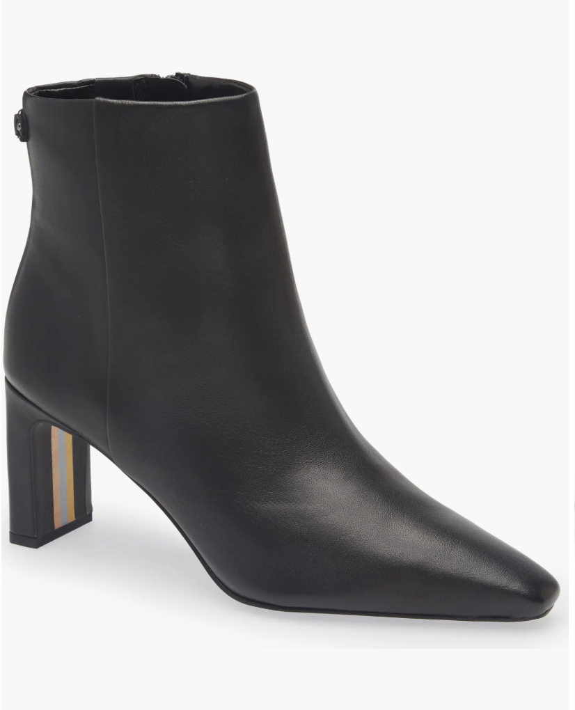 A studio product shot of the Sam Edelman Saige Bootie, a sleek black leather ankle boot with a block heel and pointed toe.