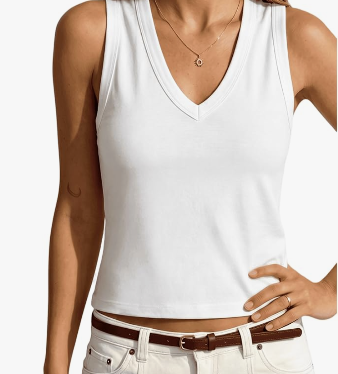 White v-neck tank top tucked into white linen pants with a brown belt — a simple and polished summer outfit for moms