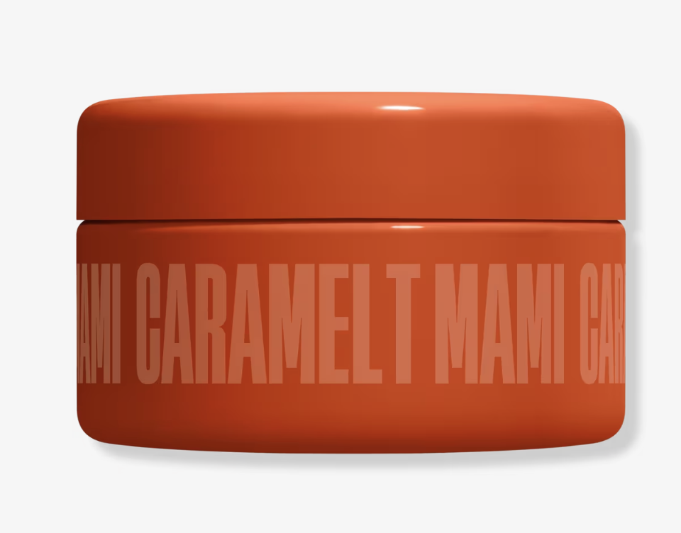 Frank Body So Polished Exfoliating Body Scrub in a round orange tub against a white background.